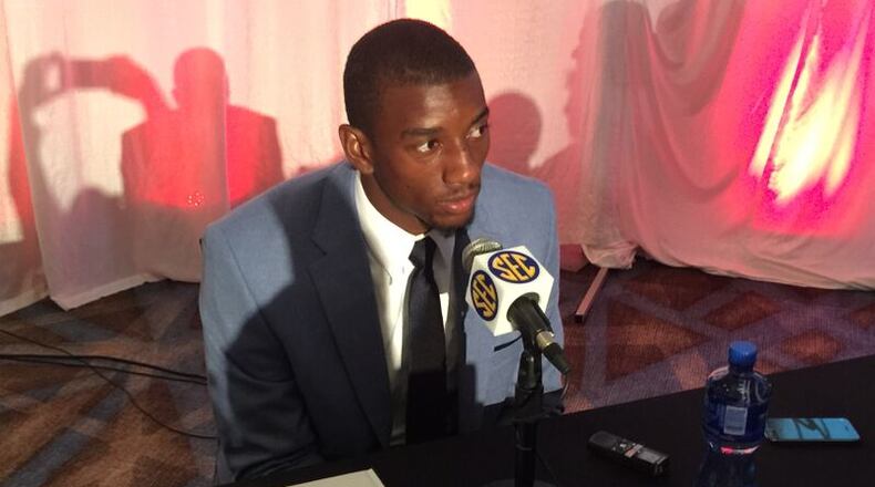 Georgia receiver Malcolm Mitchell sits on a podium at SEC Media Days on Thursday with his new children’s book, The Magician’s Hat, by his side on the table. Mitchell has become an outspoken literacy advocate in his four years at UGA, and a pretty good pass-catcher as well. (AJC / CHIP TOWERS)