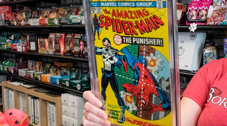 FILE - A game store manager holds the graded AM129 Spiderman "The Punisher" first issue on Sept. 10, 2021, in South Dover, Del. (Marc Clery/Delaware State News via AP, File)