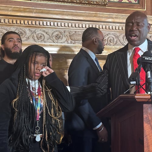 Kah'liyah Aliomar, the daughter of Corey Ruiz, who was shot and killed by a Madison police officer, wipes away tears as attorney Ben Crump speaks at a news conference on Friday, July 24, 2026, in Madison, Wis. (AP Photo/Scott Bauer)