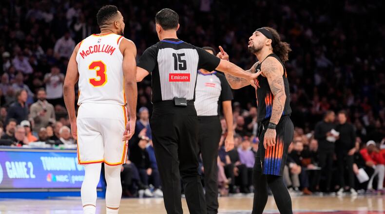 Knicks guard Jose Alvarado (right) argues with Hawks guard CJ McCollum during the second half of Game 2 of a first-round playoff series April 20, 2026, in New York. (Yuki Iwamura/AP)