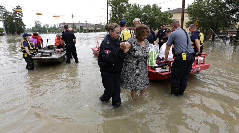 Residents are evacuated from their flooded apartment complex Tuesday, April 19, 2016, in Houston. Storms have dumped more than a foot of rain in the Houston area, flooding dozens of neighborhoods. (AP Photo/David J. Phillip)