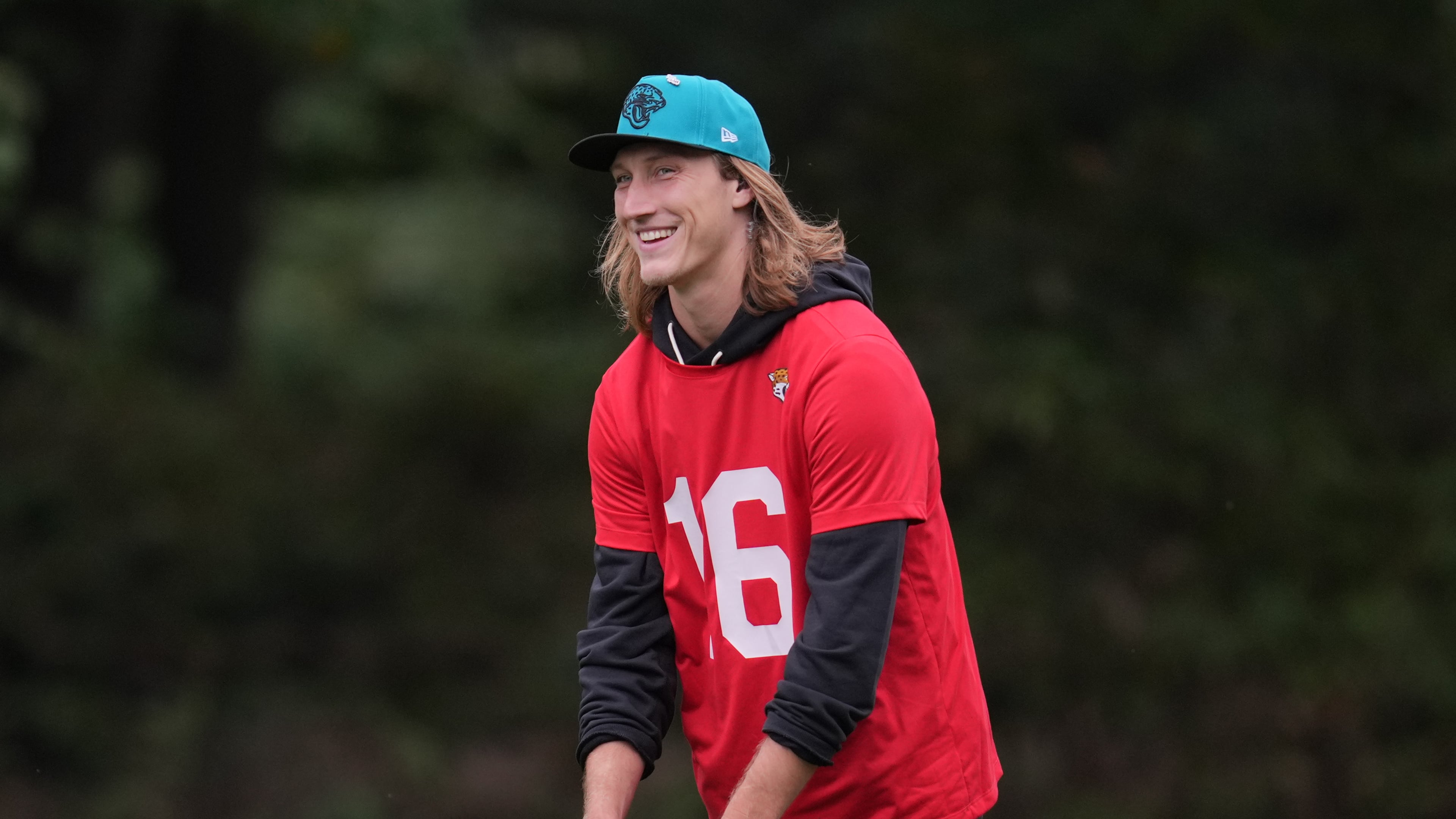 Jacksonville Jaguars quarterback Trevor Lawrence (16) smiles during an NFL football practice at The Grove in Watford, England, Wednesday, Oct. 15, 2025. (AP Photo/Kin Cheung)