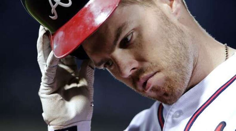 Atlanta Braves' Freddie Freeman takes his helmet off as he returns to the dugout after grounding out into a double play in the sixth inning of a baseball game against the Arizona Diamondbacks Friday, May 6, 2016, in Atlanta. The Braves lost 7-2. (AP Photo/David Goldman)
