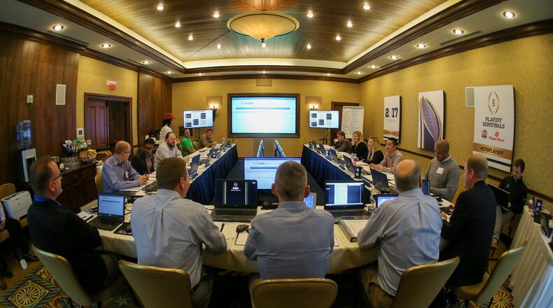 The mock selection committee discusses the finer merits of undefeated TCU and one-loss Ohio State, Stanford and Wisconsin. I’m on the right, seated in front of the poster of the trophy. (KJImages Photography)