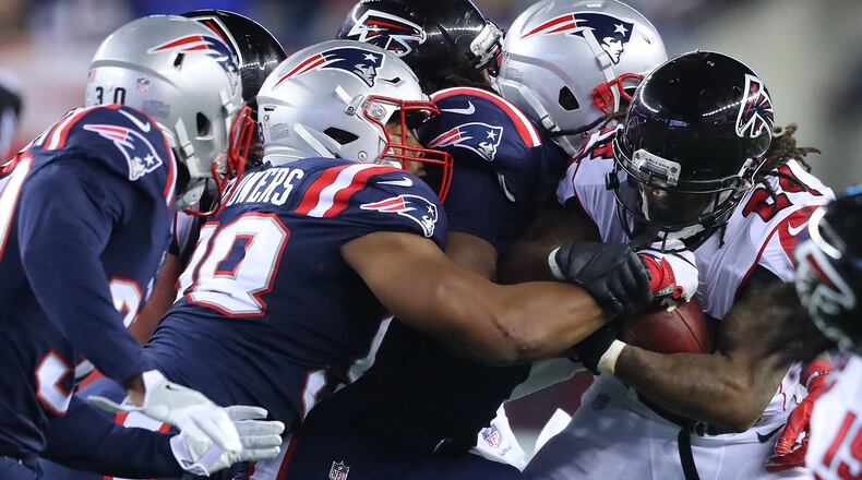 October 22, 2017 Foxborough: The Patriots defense stops Falcons running back Devonta Freeman at the line of scrimmage during the first half in a NFL football game on Sunday, October 22, 2017, in Foxborough.   Curtis Compton/ccompton@ajc.com