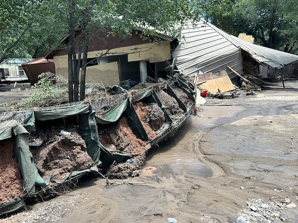 In this photo provided by Barbara Arthur, damage with mud and debris from flash flooding is seen outside a house at the Riverside RV Park, Wednesday, July 9, 2025, in Ruidoso, N.M. (Barbara Arthur via AP)