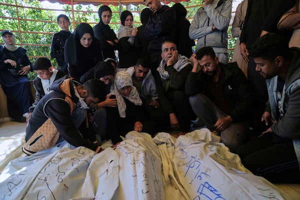 Palestinians mourn over the bodies of their relatives killed in an Israeli army airstrike, during their funeral in Khan Younis, southern Gaza Strip, Saturday, April 19, 2025. (AP Photo/Abdel Kareem Hana)