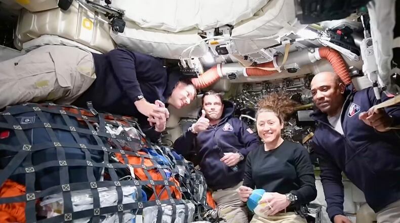 This image taken from video provided by NASA shows the Artemis II crew, from left, Canadien astronaut and mission specialist Jeremy Hansen, Commander Reid Wiseman, mission specialist Christina Koch and pilot Victor Glover as they speak with NASA Mission Control via video conference from the moon's orbit Thursday, April 2, 2026. (NASA via AP)