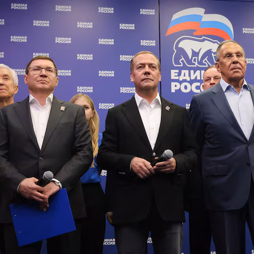 Russian Security Council Deputy Chairman and the head of the United Russia party Dmitry Medvedev, center, and Russian Foreign Minister Sergey Lavrov, center right, stand with other party members as they watch preliminary voting results for Russian parliamentary elections at the United Russia's headquarters in Moscow, Russia, Sunday, Sept. 20, 2026. (Ekaterina Shtukina, Sputnik, Kremlin Pool Photo via AP)