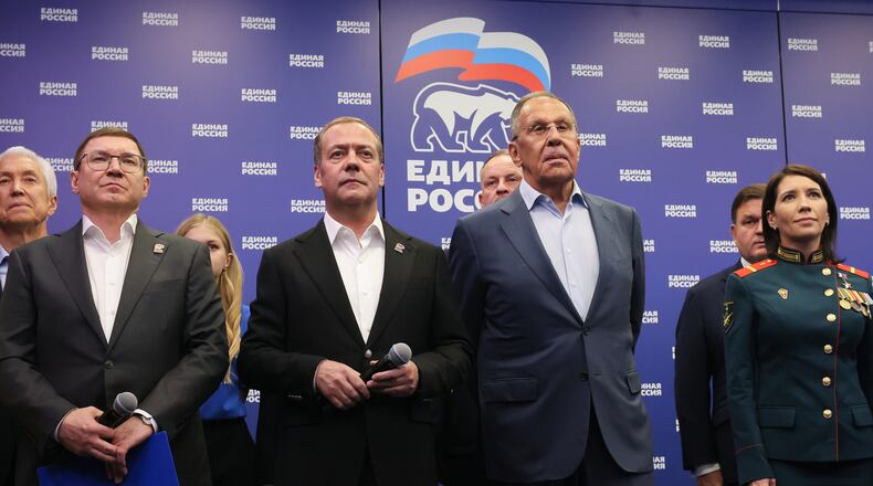 Russian Security Council Deputy Chairman and the head of the United Russia party Dmitry Medvedev, center, and Russian Foreign Minister Sergey Lavrov, center right, stand with other party members as they watch preliminary voting results for Russian parliamentary elections at the United Russia's headquarters in Moscow, Russia, Sunday, Sept. 20, 2026. (Ekaterina Shtukina, Sputnik, Kremlin Pool Photo via AP)