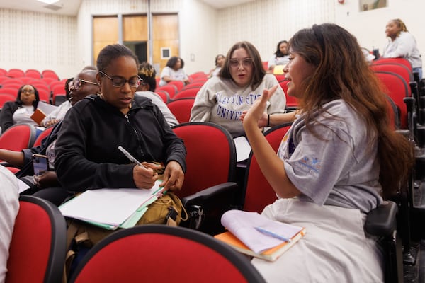 At the end of the IGNITE’s Resident Summer Experience, mentors and residents discuss one thing each expects for the first week while at Stone Mountain High School. (Estela Muñoz/AJC)