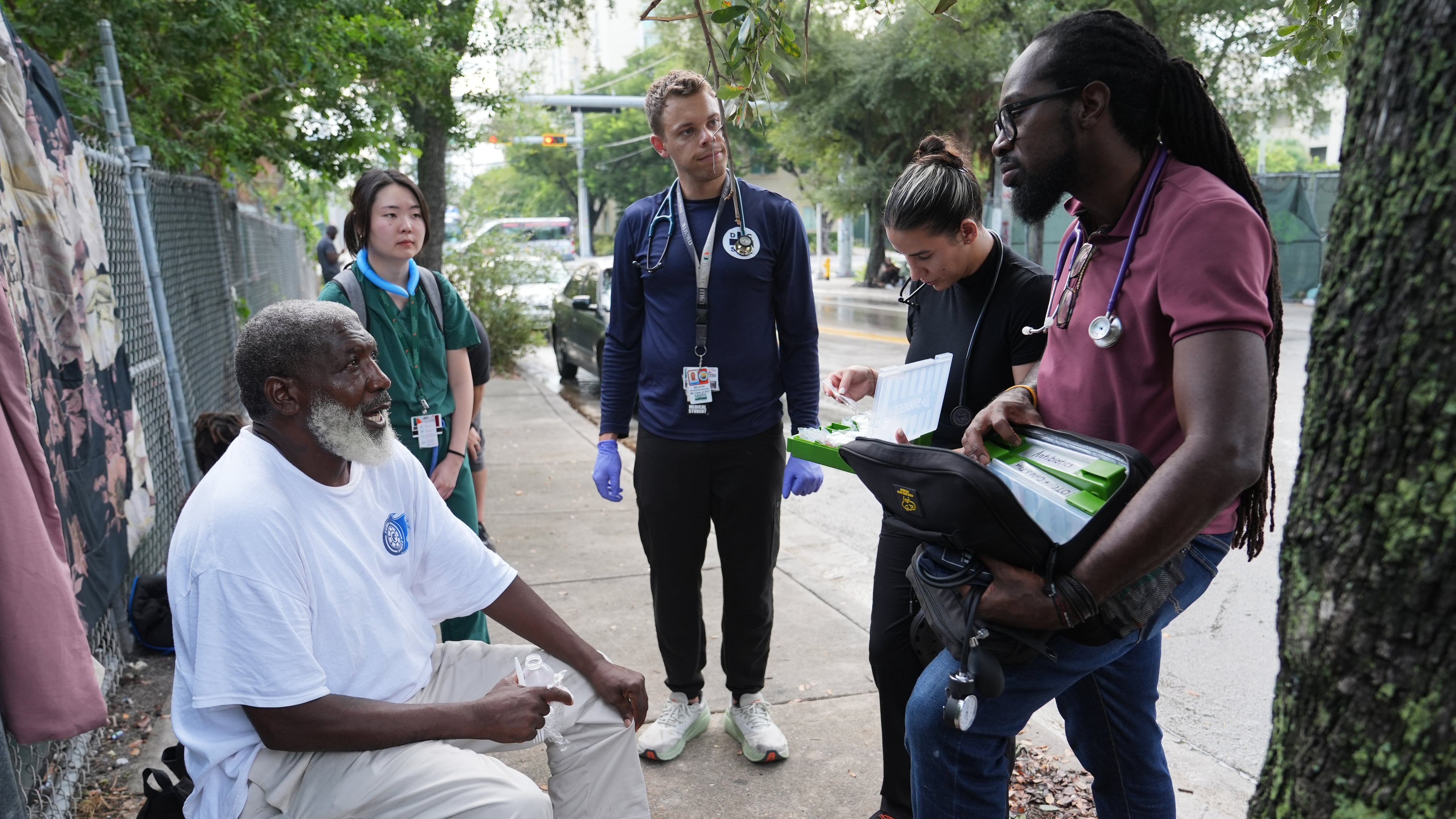 Dr. Inaki Bent, right, talks with Jonas Richards, left, while working with the Miami Street Medicine team to provide medical services to homeless people, Saturday, Aug. 23, 2025, in Miami. (AP Photo/Lynne Sladky)