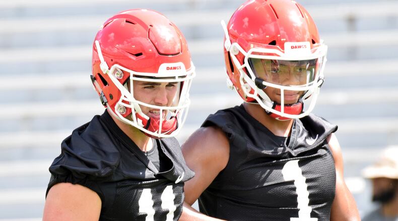 Georgia quarterbacks Jake Fromm (11) and Justin Fields (1) during the Bulldogs' practice Saturday, Aug. 4, 2018, at Sanford Stadium in Athens.