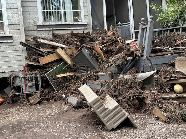 In this photo provided by Barbara Arthur, damage from flash flooding with mud and debris is seen outside a house at the Riverside RV Park, Wednesday, July 9, 2025, in Ruidoso, N.M. (Barbara Arthur via AP)