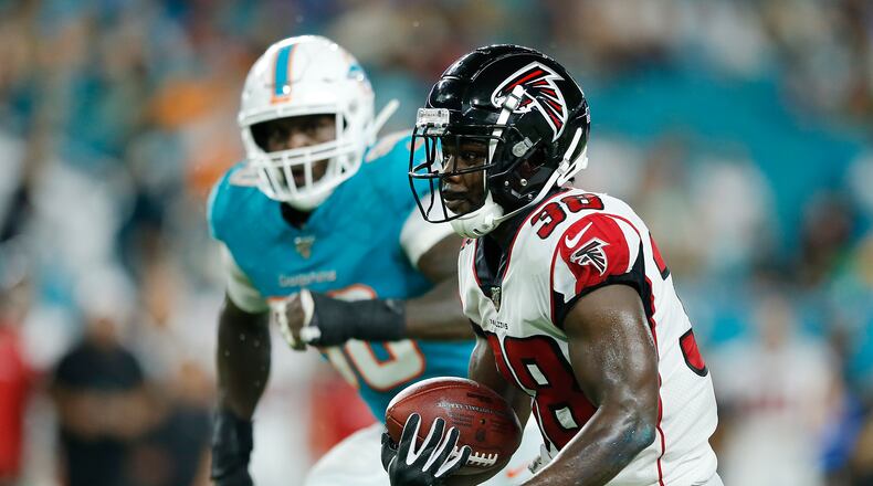 Kenjon Barner #38 of the Atlanta Falcons runs with the ball after a reception against the Miami Dolphins during the second quarter of the preseason game at Hard Rock Stadium on August 08, 2019 in Miami, Florida. (Photo by Michael Reaves/Getty Images)