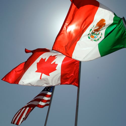 FILE - National flags representing the United States, Canada, and Mexico fly in the breeze in New Orleans where leaders of the North American Free Trade Agreement met on April 21, 2008. (AP Photo/Judi Bottoni, File)