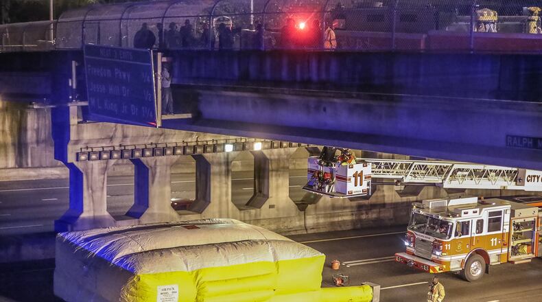 A man threatened to jump from an interstate sign on the Courtland Street bridge over I-75/I-85 southbound early Wednesday, March 30, 2016 in Atlanta. JOHN SPINK/ JSPINK@AJC.COM