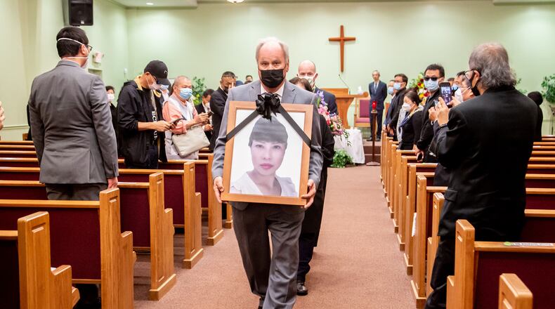 A photograph of Daoyou Feng is carried out of Lee's Funeral Home after her funeral in Norcross on April 4. The 44-year-old was among the eight people slain in metro Atlanta spa shootings last month. (Photo: Steve Schaefer for The Atlanta Journal-Constitution)