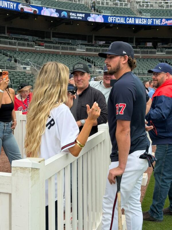 Country artist Mackenzie Carpenter chats with Braves third baseman Austin Riley before a game on April 28. (Gabriel Burns/AJC)