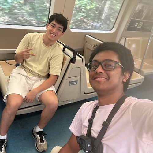 Andrew Zhang (left) and Ayush Maini pose on a MARTA train in middle of their attempt to visit all train stations in record time. Guinness World Records has to confirm their time to make a record official. (Courtesy of Ayush Maini)