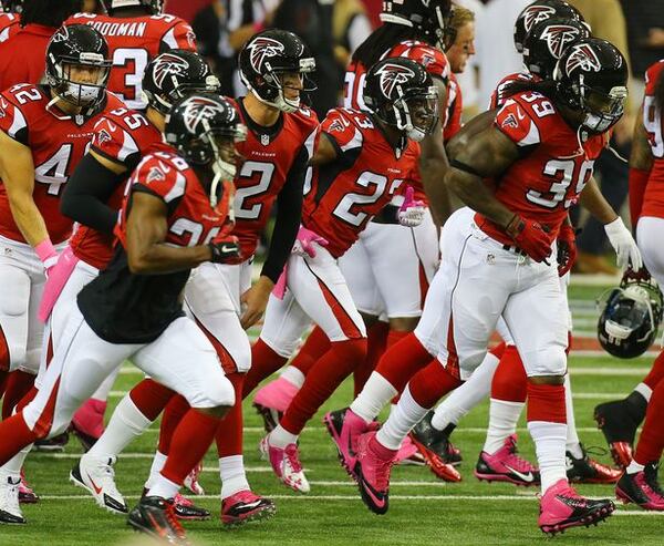 Matt Ryan and the Falcons sport pink shoes for breast cancer awareness taking the field to prepare to play the Bears on Sunday, Oct. 12, 2014, in Atlanta. (Photo by Curtis Compton)