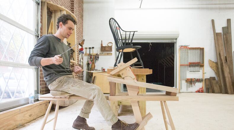 Local woodworker Kendrick Anderson works on a piece of furniture in his Castleberry Hill studio.