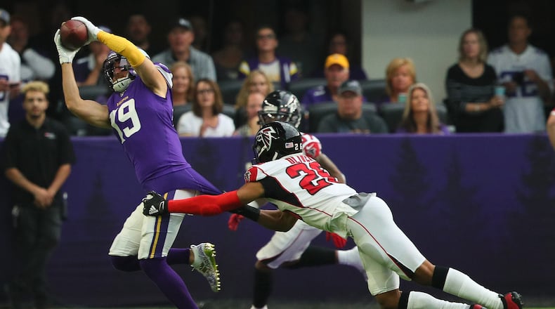 MINNEAPOLIS, MN - SEPTEMBER 08: Adam Thielen #19 of the Minnesota Vikings pulls in a pass for a 23 yard touchdown while Isaiah Oliver #26 of the Atlanta Falcons attempt the tackle in the first quarter at U.S. Bank Stadium on September 8, 2019 in Minneapolis, Minnesota. (Photo by Adam Bettcher/Getty Images)
