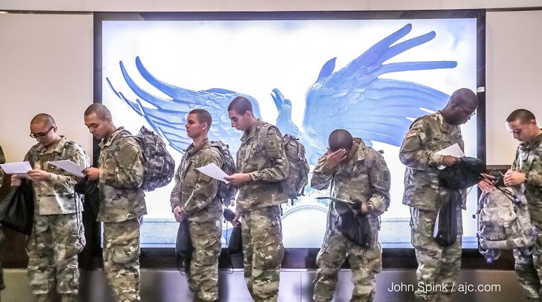 Fort Benning soldiers at Hartsfield-Jackson heading home for the holidays for two weeks. Credit: John Spink / AJC