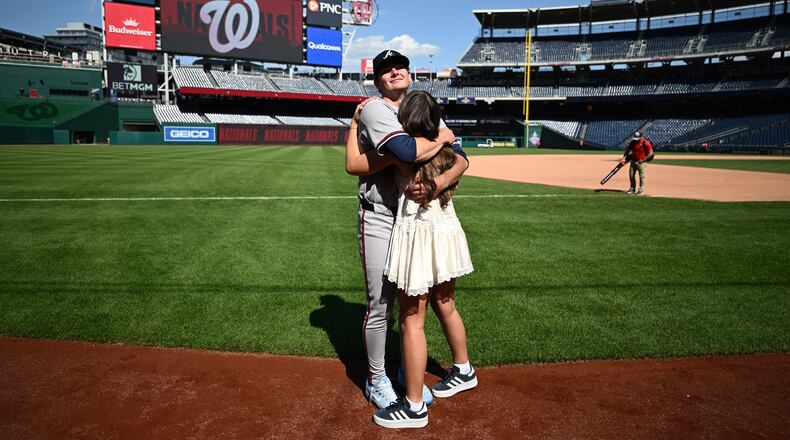 Atlanta Braves starting pitcher JR Ritchie, back, hugs his fiancée Makena Miller after winning his major league debut baseball game against the Washington Nationals, Thursday, April 23, 2026, in Washington. (AP Photo/Nick Wass)