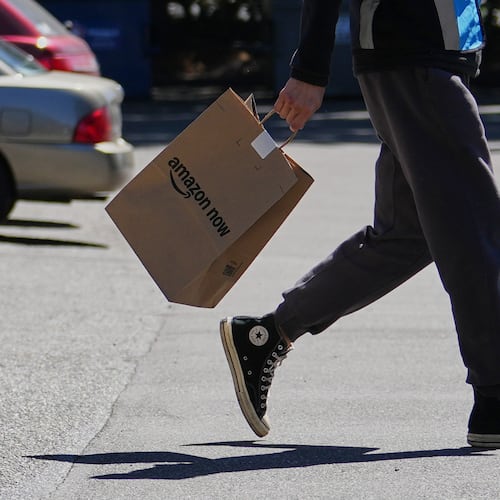 A driver picks up an order at an Amazon Now location, Monday, May 11, 2026, in Bellevue, Wash. (AP Photo/Lindsey Wasson)