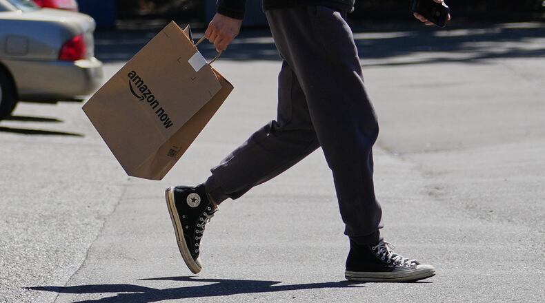 A driver picks up an order at an Amazon Now location, Monday, May 11, 2026, in Bellevue, Wash. (AP Photo/Lindsey Wasson)