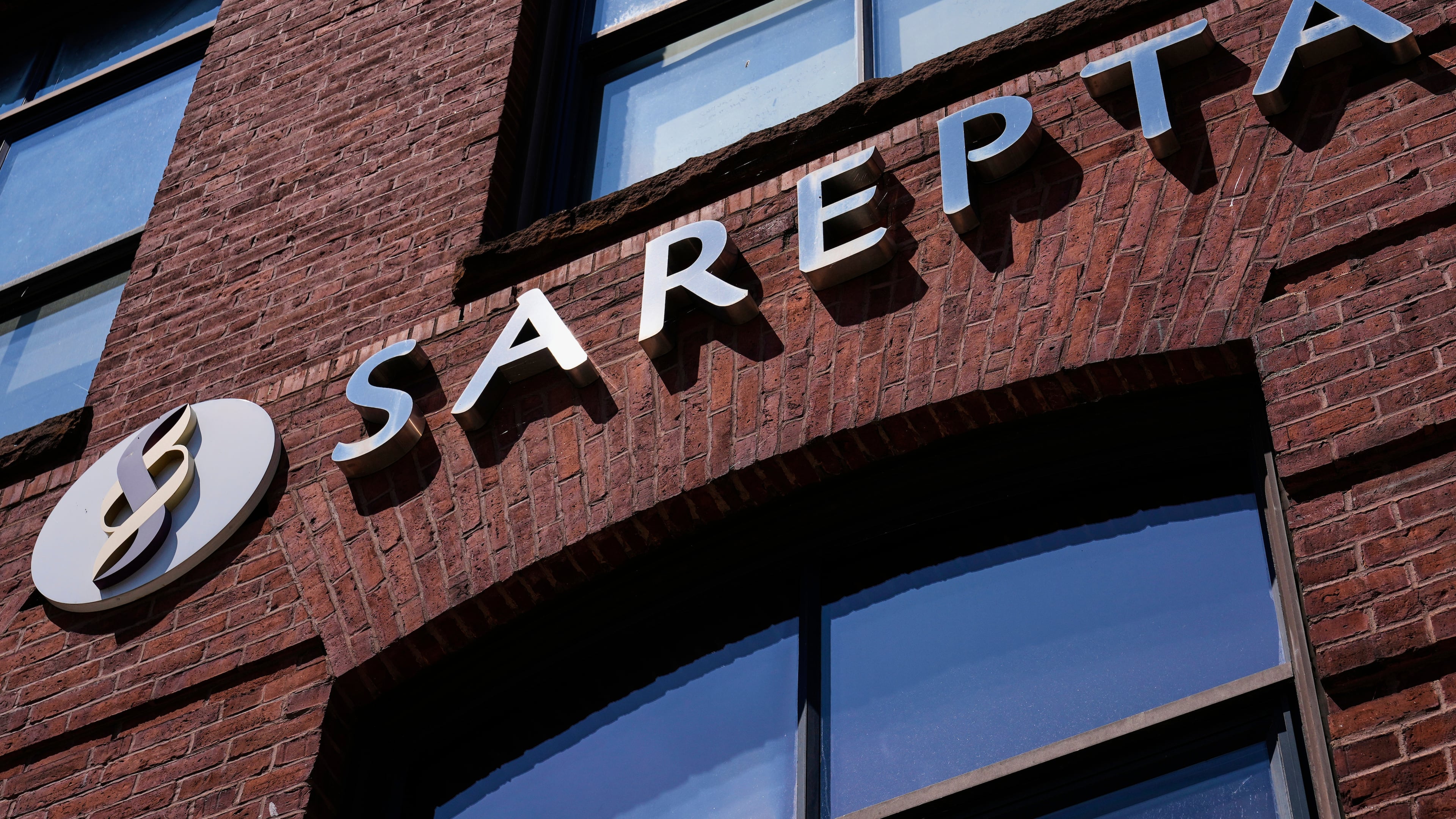 FILE - The name and logo of Sarepta Therapeutics is displayed on the company's headquarters, Monday, July 28, 2025, in Cambridge, Mass. (AP Photo/Charles Krupa, File)