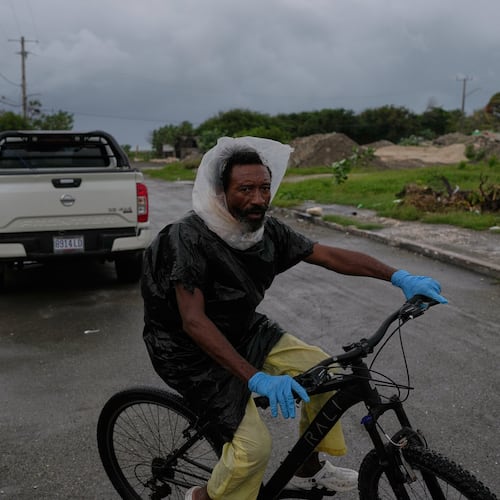 A man rides a bicycle ahead of the forecast arrival of Hurricane Melissa in Kingston, Jamaica, Sunday, Oct. 26, 2025. (AP Photo/Matias Delacroix)