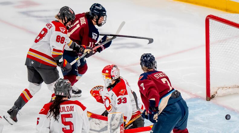 Montreal Victoire's Abby Roque (11) scores on Ottawa Charge goaltender Gwyneth Philips (33) during overtime of a PWHL playoff hockey game in Laval, Quebec, Thursday, May 14, 2026. (Christopher Katsarov/The Canadian Press via AP)
