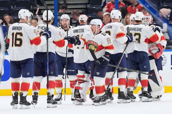 Florida Panthers players celebrate after defeating the against the Tampa Bay Lightning during Game 1 of an NHL hockey Stanley Cup first-round playoff series, Tuesday, April 22, 2025, in Tampa, Fla. (AP Photo/Chris O'Meara)