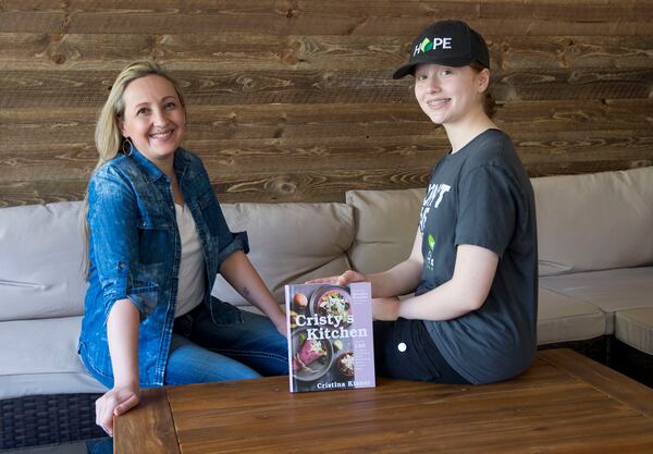 Cristy Kisner poses for a photo with her daughter Julieta Gracey Kisner Saturday, April 1, 2023 at her restaurant in Roswell. Julieta drew many of the illustrations in her mother’s cookbook. (Daniel Varnado / For the AJC)