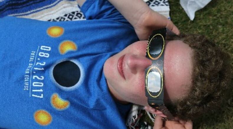 Gabriel Green, 16, of Dunwoody, takes in the total solar eclipse in Clayton, a city in the path of totality in North Georgia. CURTIS COMPTON / CCOMPTON@AJC.COM