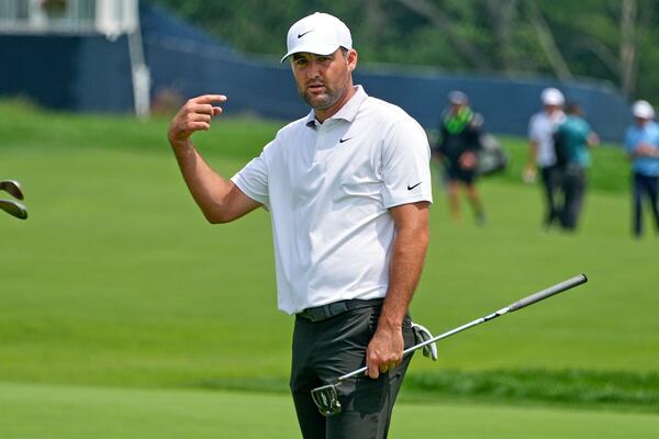 Scottie Scheffler gestures after putting on the 14th green during a practice round for the 2025 US Open golf championship at Oakmont Country Club in Oakmont, Pa., Monday, June 9, 2025. (AP Photo/Gene J. Puskar)