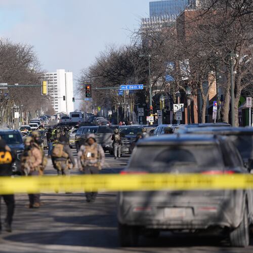 Federal agents stand near the site of a shooting Saturday, Jan. 24, 2026, in Minneapolis. (AP Photo/Abbie Parr)