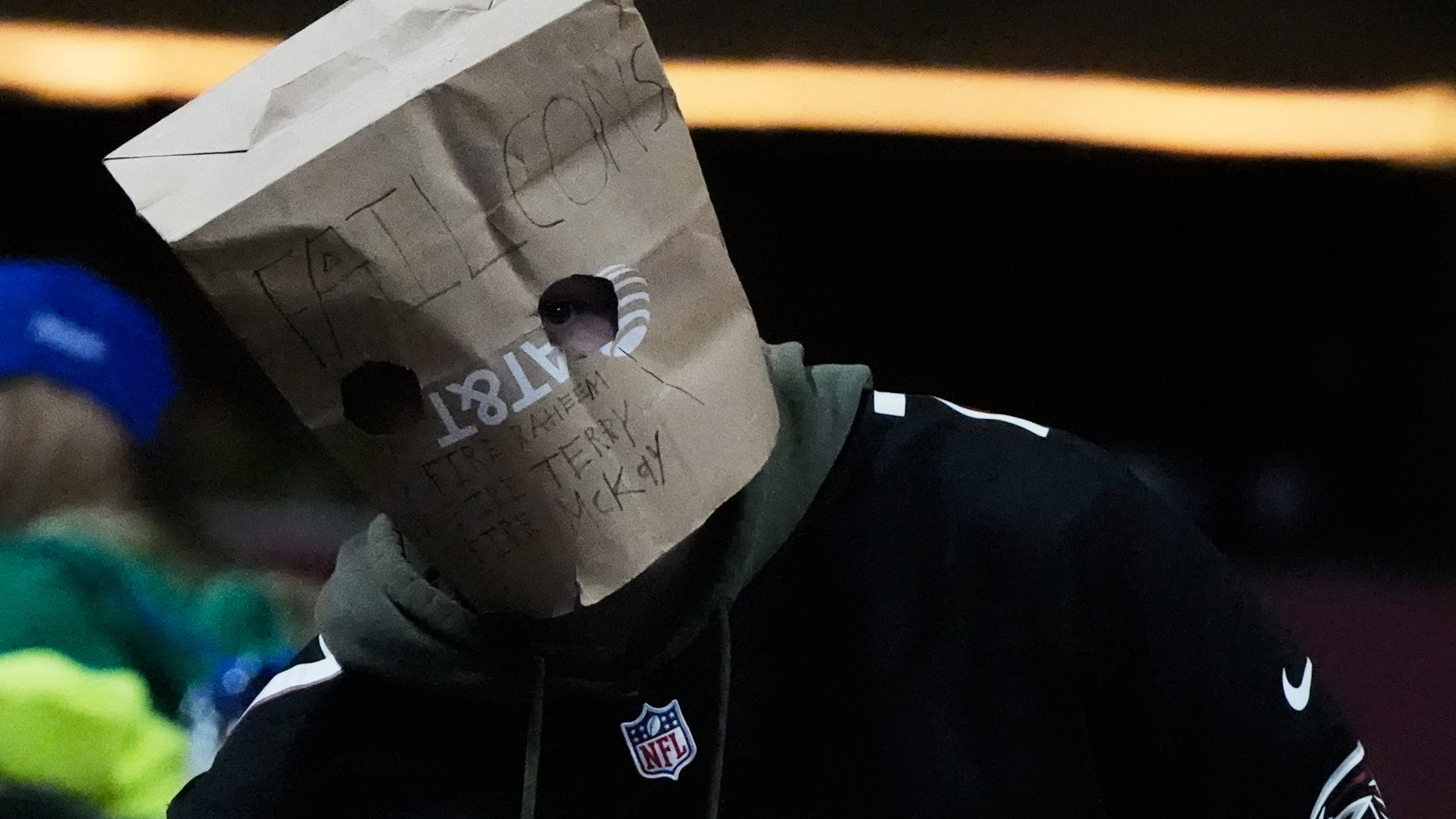 An Atlanta Falcons fan wears a paper bag on their head during the second half of an NFL football game against the Seattle Seahawks, Sunday, Dec. 7, 2025, in Atlanta. (AP Photo/Mike Stewart)