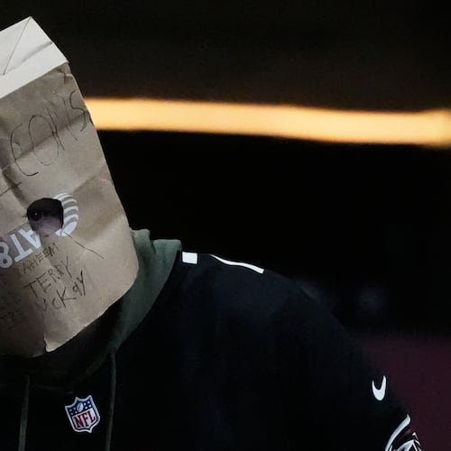 An Atlanta Falcons fan wears a paper bag on their head during the second half of an NFL football game against the Seattle Seahawks, Sunday, Dec. 7, 2025, in Atlanta. (AP Photo/Mike Stewart)