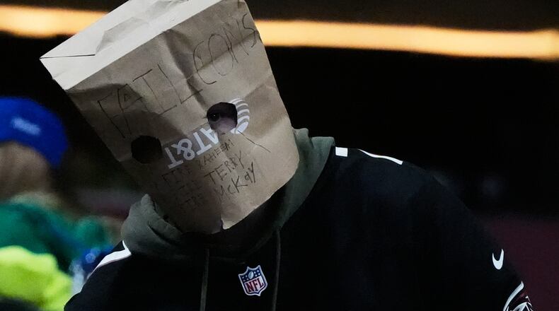 An Atlanta Falcons fan wears a paper bag on their head during the second half of an NFL football game against the Seattle Seahawks, Sunday, Dec. 7, 2025, in Atlanta. (Mike Stewart/AP)