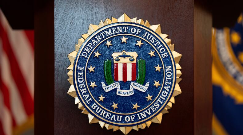 FILE - An FBI seal is displayed on a podium before a news conference at the field office in Portland, Ore., Jan. 16, 2025. (AP Photo/Jenny Kane, File)