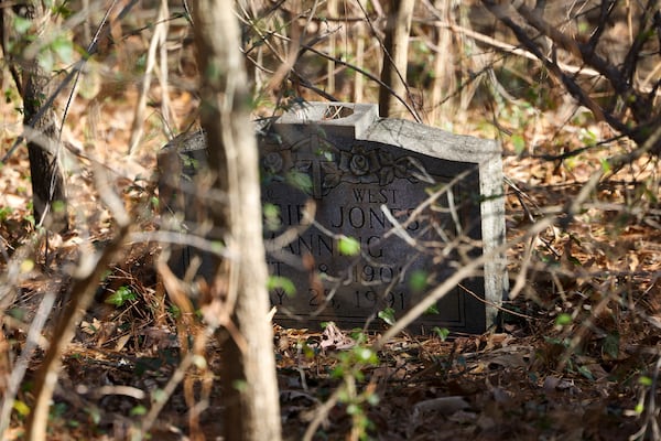 Gravestones in the Piney Grove Cemetery will soon be cleared of vegetation under an agreement between descendants of people buried their and the Buckhead HOA that owns the property. (Jason Getz/AJC 2024)