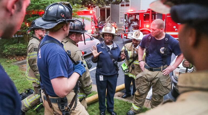 DeKalb fire Battalion Chief Vera Morrison briefs firefighters after seven people were rescued from an apartment building on Fri., May 20, 2016. JOHN SPINK / JSPINK@AJC.COM