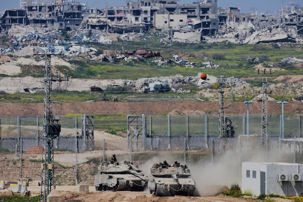 FILE - Israeli tanks maneuver along the border with north of the Gaza Strip, as seen from southern Israel, March 18, 2025. (AP Photo/Ohad Zwigenberg, File)