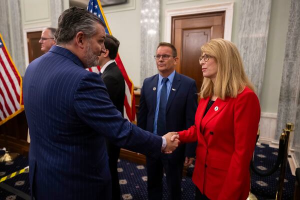 Sheri Lilley shakes hands with Sen.  Ted Cruz (R-Texas) following a July 29, 2025 press conference unveiling new aviation safety legislation in response to the Jan. 29 mid-air collision. Cruz's Republican-sponsored "ROTOR Act" is one of three bills that have been introduced since the crash. The Lilleys hope Republicans and Democrats come together on a bipartisan package. (Craig Hudson for the AJC)