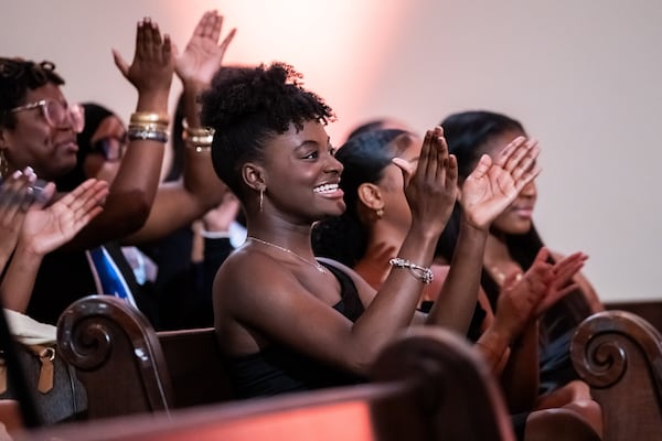 250412 ATLANTA, GA — 2023 Miss Spelman third attendant Nadia Scott applauds during the 42nd annual Miss Spelman pageant at Spelman College’s Sisters Chapel in Atlanta on Saturday, April 12, 2025. 
(Bita Honarvar for The Atlanta Journal-Constitution)