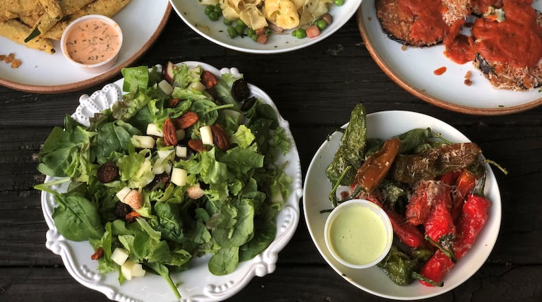 A feast of takeout from A Mano in the Old Fourth Ward (clockwise from upper left): fried okra, carbonara, eggplant Parmesan, blistered shishitos and fig salad. CONTRIBUTED BY WENDELL BROCK