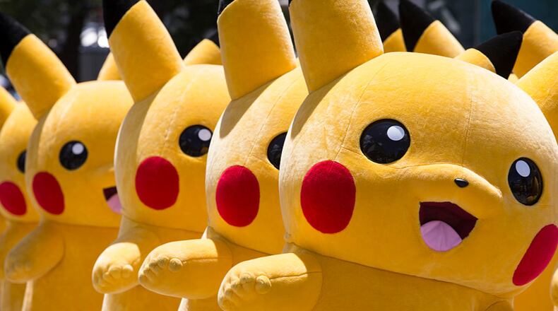 YOKOHAMA, JAPAN - AUGUST 07: Performers dressed as Pikachus march during the Pikachu Outbreak event hosted by The Pokemon Co. on August 7, 2016 in Yokohama, Japan.(Photo by Tomohiro Ohsumi/Getty Images)